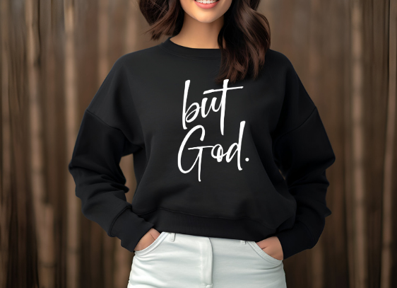 woman wearing a black Christian themed sweatshirt that reads "but God." with white font