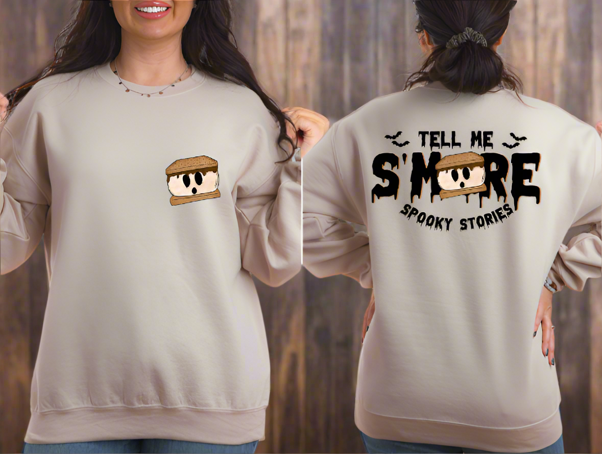 women wearing sand sweatshirt with text "tell me smore spooky stories"